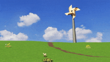 a windmill in the middle of a grassy hill