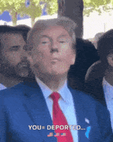 a man in a blue suit and red tie says you deported