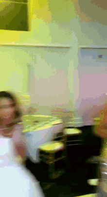 a blurry picture of a woman sitting at a table in a restaurant