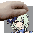 a hand is touching a cartoon girl 's face with a hat on .