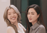 two women are posing for a picture and one of them has the word lingerie on the bottom right