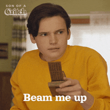 a man in a yellow sweater is holding a remote control with the words beam me up below him