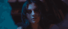 a close up of a woman 's face with a blue background
