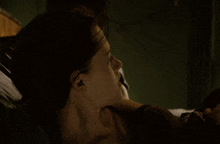 a close up of a woman laying on a bed
