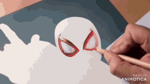 a person is drawing a spider-man with a pencil