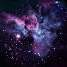 a purple and blue galaxy with lots of stars in the sky .