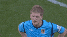 a soccer player wearing a blue shirt that says totes
