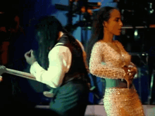 a man is playing a guitar and a woman is singing on stage