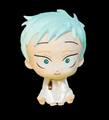 a small figurine of a boy with blue hair and green eyes