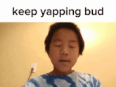 a young boy with his eyes closed and the words keep yapping bud behind him