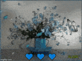 a bouquet of blue flowers in a blue vase with the name alma on the bottom right