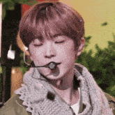 a close up of a person with a microphone in their mouth