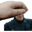 a hand is touching a man 's face in a pixel art .