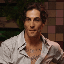 a man with a tattoo on his chest that says o della