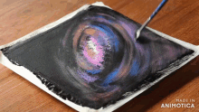 a painting of a galaxy is being made in animatica