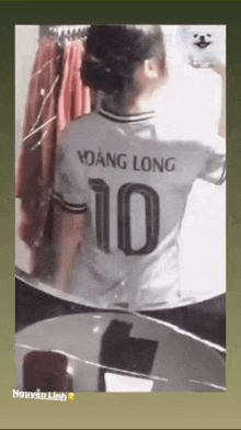 a woman is wearing a white shirt with the number 10 on the back