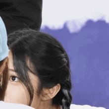 a woman is covering her face with a white cloth