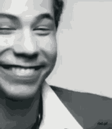 a close up of a man 's face smiling with his eyes closed .