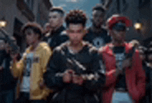 a group of young men standing next to each other on a street holding guns .