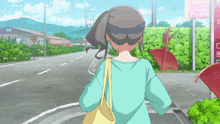 a girl in a blue shirt is walking down a street in front of a sign that says happy