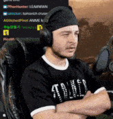 a man wearing headphones and a black shirt that says altitude