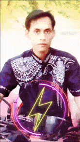 a man wearing a purple shirt with a lightning bolt on his chest