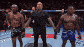 a referee stands between two fighters in a ufc fight