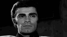 a close up of a man 's face in a black and white photo .