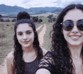 two girls wearing sunglasses are standing next to each other