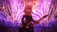 a girl in a black dress is playing a guitar