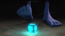 a blue foot is standing next to a blue cube