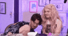 a man and a woman are sitting next to each other in a room
