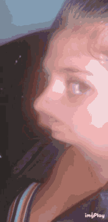 a close up of a woman 's face with a blurred background
