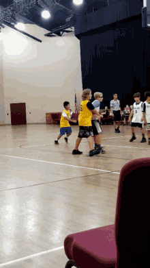 a group of young boys are playing a game of basketball and one of the boys has the number 8 on his shirt