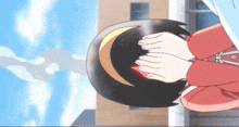 a girl in a red shirt is kneeling down with her hands folded in front of her face