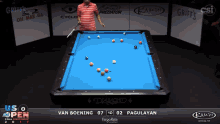 a pool table with a man standing in front of it and a scoreboard that says van boening 07 10 02 pagulayan