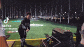 a tiktok video of a girl playing golf at night