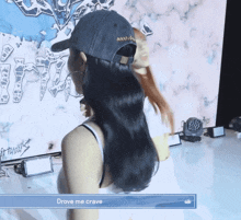 a woman wearing a hat that says " drove me crave " on it