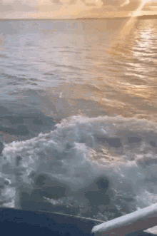 the sun is shining through the clouds on the ocean