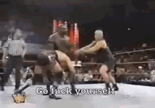 two wrestlers are fighting in a ring and the words go fuck yourself are visible