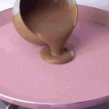 a bowl of chocolate is being poured into a pan that says mr. cakes