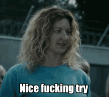 a woman in a blue shirt with the words nice fucking try below her