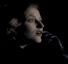 a black and white photo of a woman 's face with the words whatever written below her .