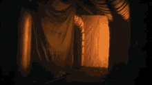 a dark room with a light coming out of the door
