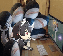 a girl in a maid costume sits in front of a computer screen