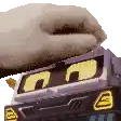 a close up of a toy truck with a hand on top .