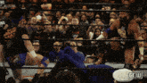 two wrestlers in a ring with the word gell on the bottom left