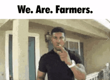 a man in a black shirt is pointing at the camera with the words we are farmers above him .