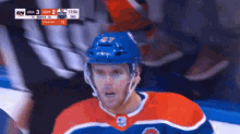 a hockey player wearing a blue helmet with the number 37 on the front