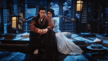 a man and a woman are sitting next to each other in a dark room